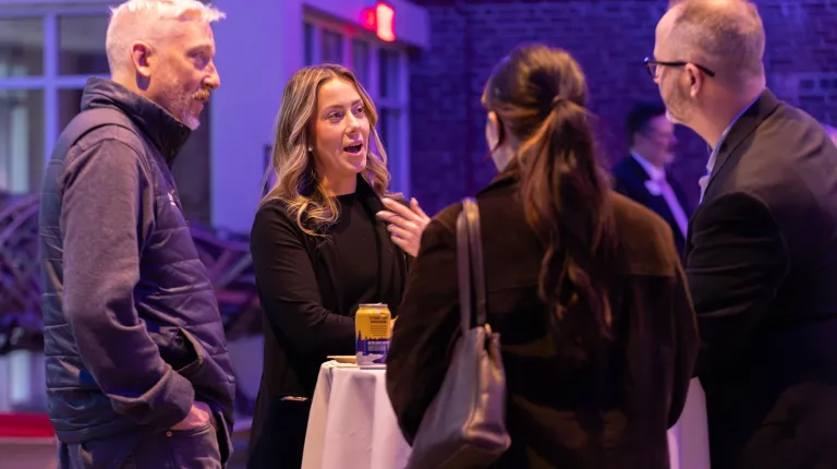 Community members network during cocktail hour