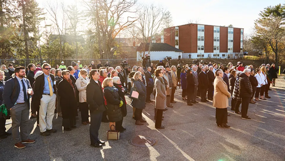 A large group gathers to watch remarks at the groundbreaking ceremony