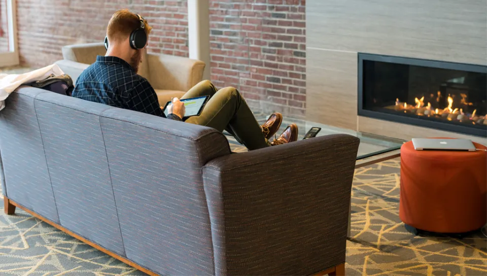 A student studies in front of a fireplace