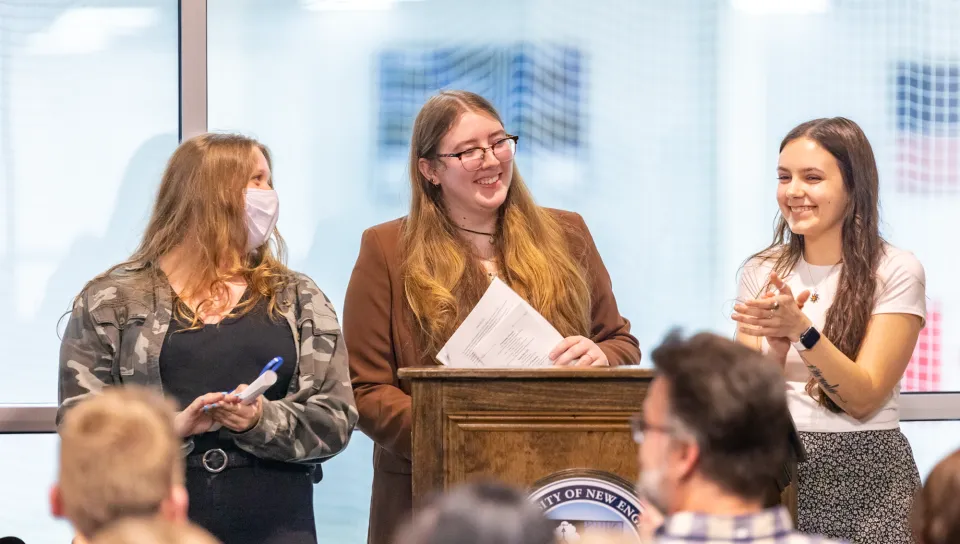 PSI CHI officers speak at the podium