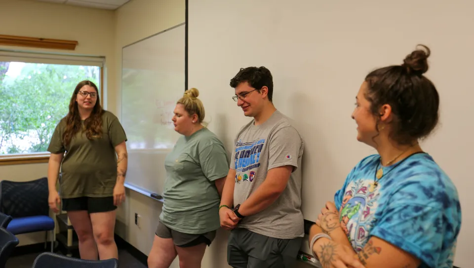 students mentors standing in front of classroom