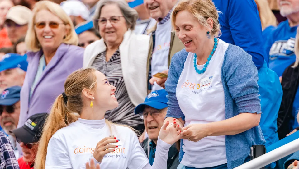 UNE First Lady Lynn Brandsma greets a student