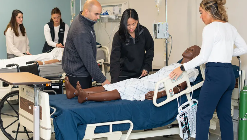 A group of physical therapy students in the simulation lab