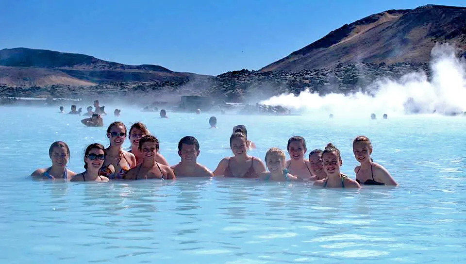 A goup of U N E students swimming in the Blue Lagoon geothermal spring