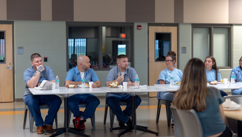 Residents of the Maine Correctional Center answer questions from UNE students. 