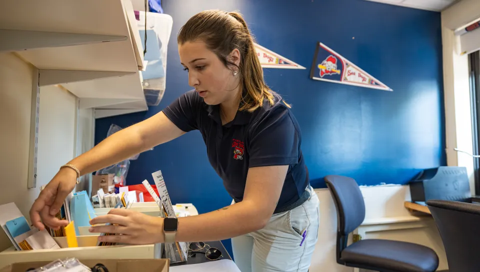 Samantha Fickett combs through ticket materials at the Sea Dogs ticket booth