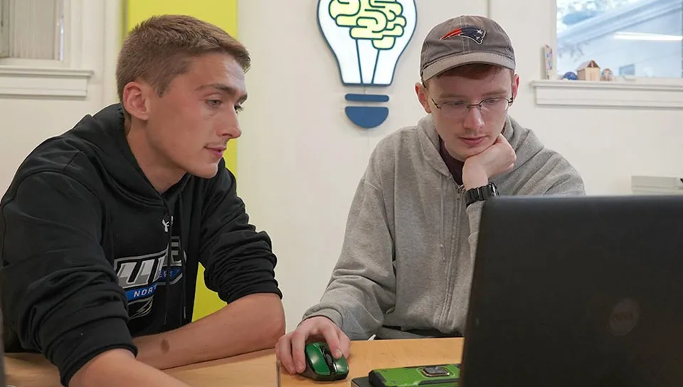 Image of students in the makerspace working on laptops