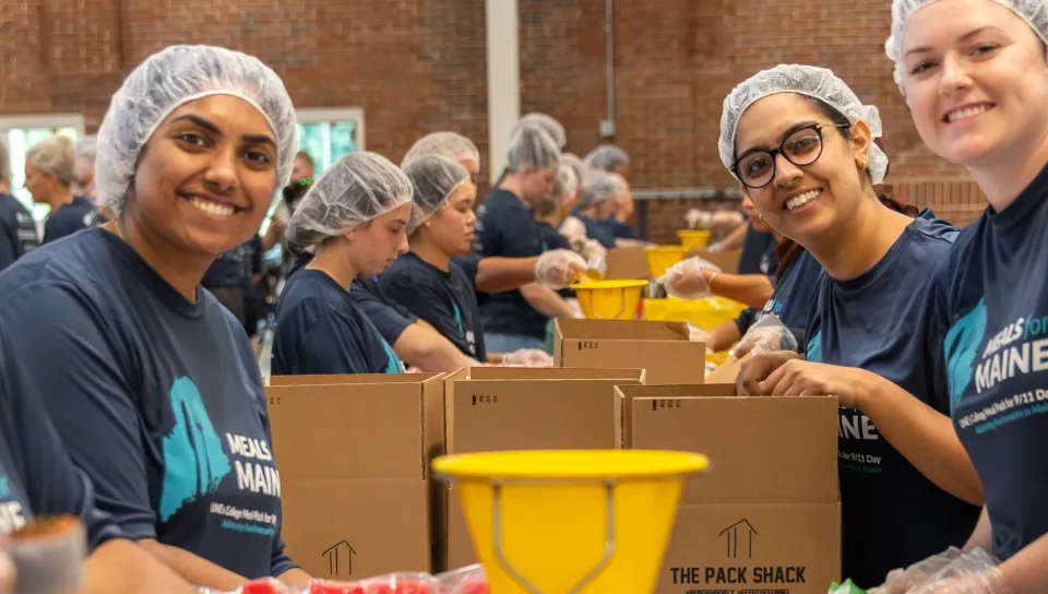 Meals to Maine workers help prepare meal kits.