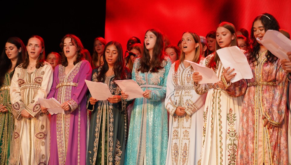 UNE students sing the Moroccan national anthem at the 10th anniversary ceremony