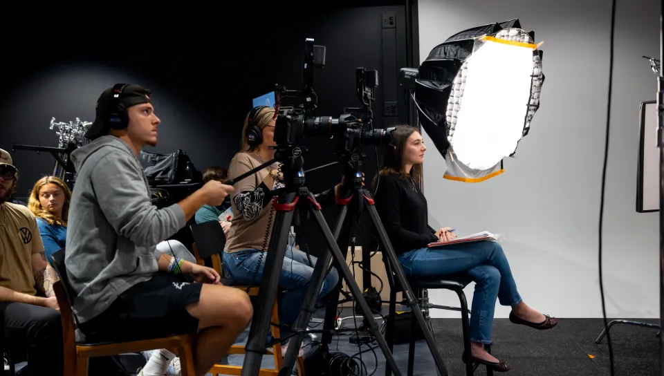 UNE students conduct an interview in the Nor'easter Production Studio using video and lighting equipment