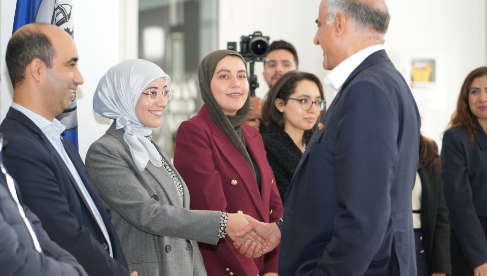 Ambassador Talwar greets a student