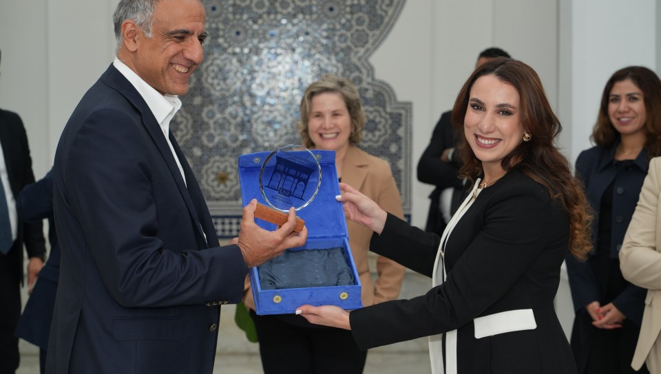 Ambassador Talwar accepts a gift from Douaa Ben Imran