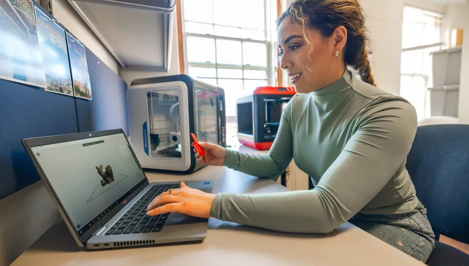 A student works on her laptop