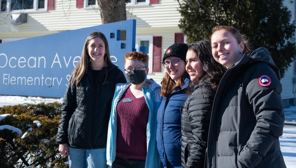 UNE students pose for a photo outside Ocean Avenue Elementary School