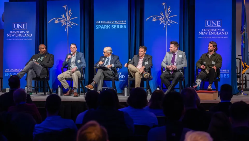 Panelists speak onstage in Innovation Hall