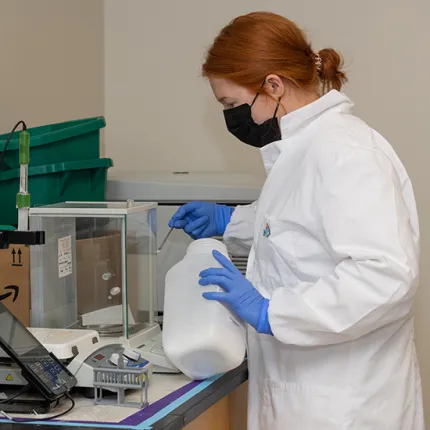 A student weighs a powder compound