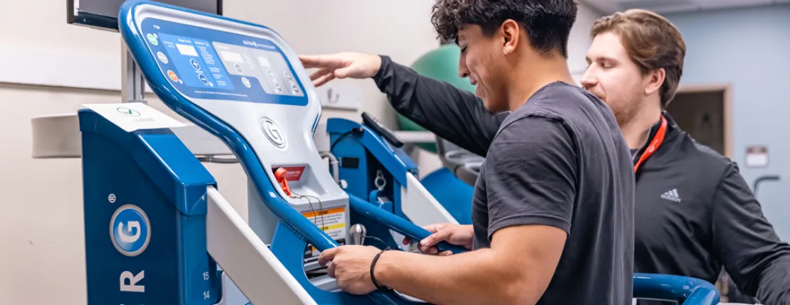 A previous D P T student assists a patient to walk on an anti-gravity treadmill at Maine Medical Center