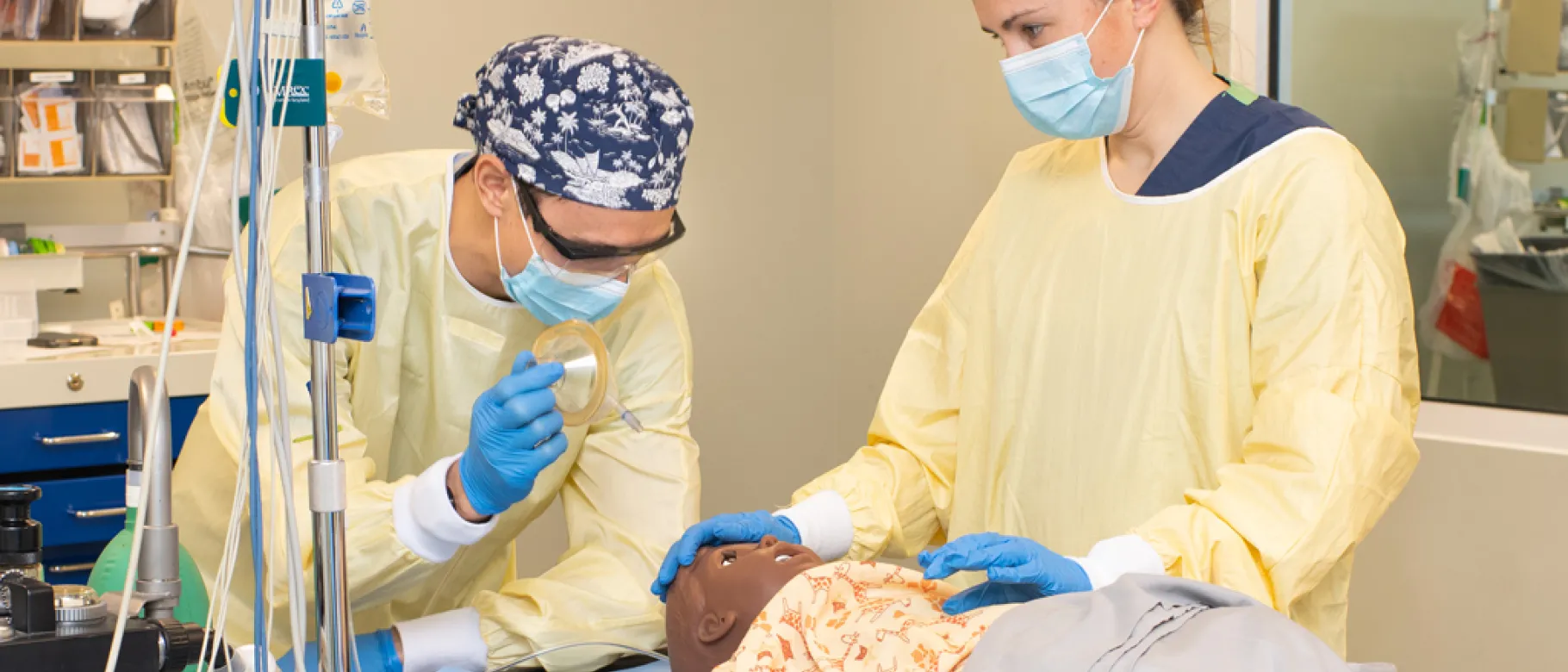 Two U N E D N P students practice on a patient simulator