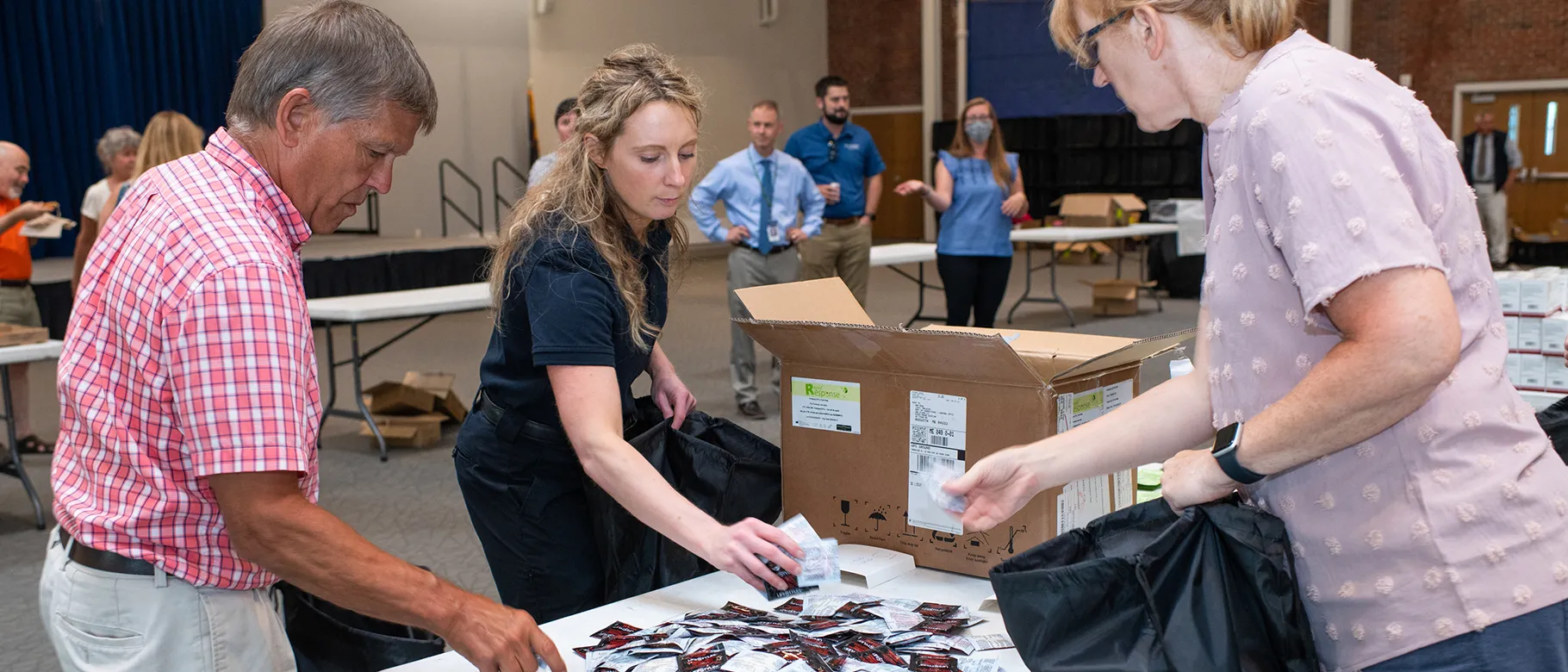 UNE students place contraceptives into harm reduction bags