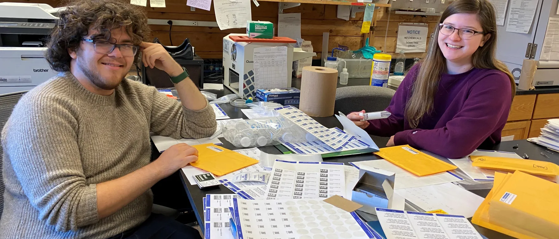 UNE student Brooke Parks sits with MDI Biological Laboratory independent study student, Adam Feher.