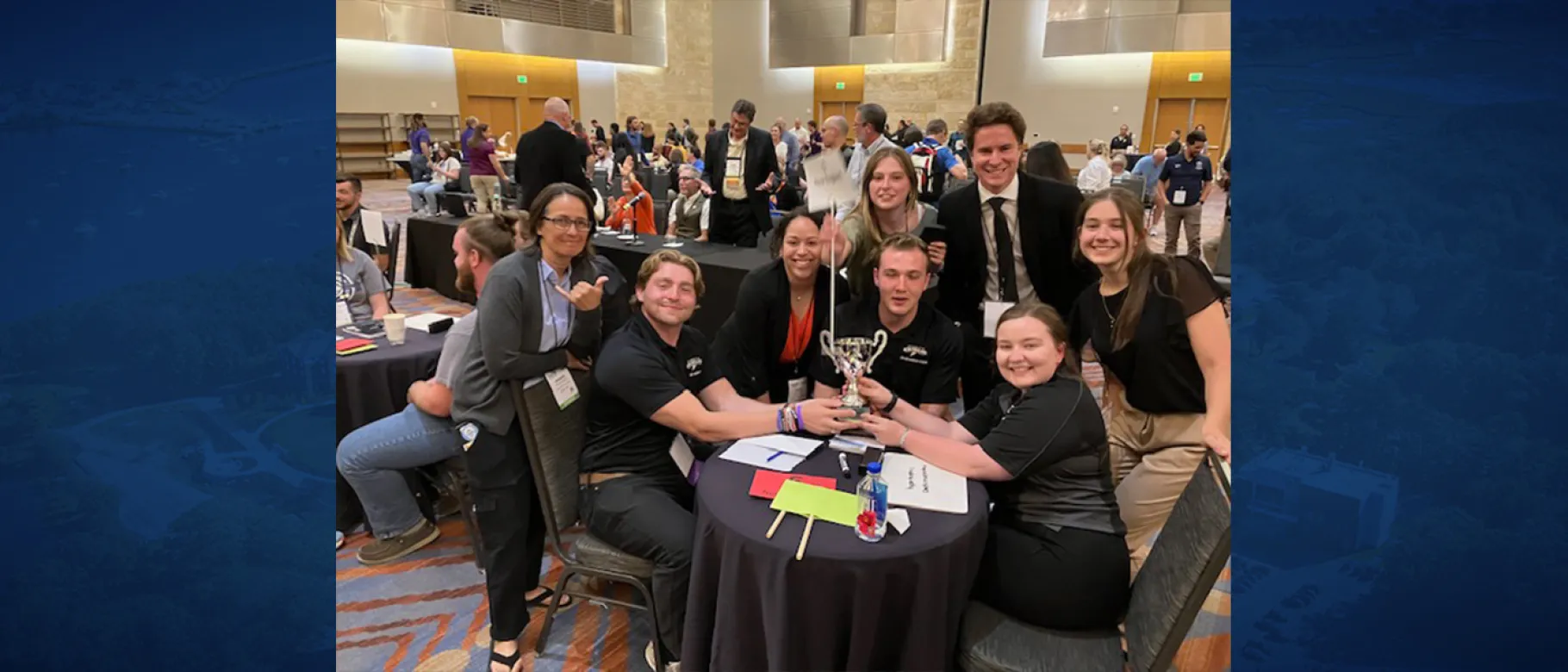 UNE Applied Exercise Science students gather at a table following their win at the American College of Sports Medicine National Quiz Bowl