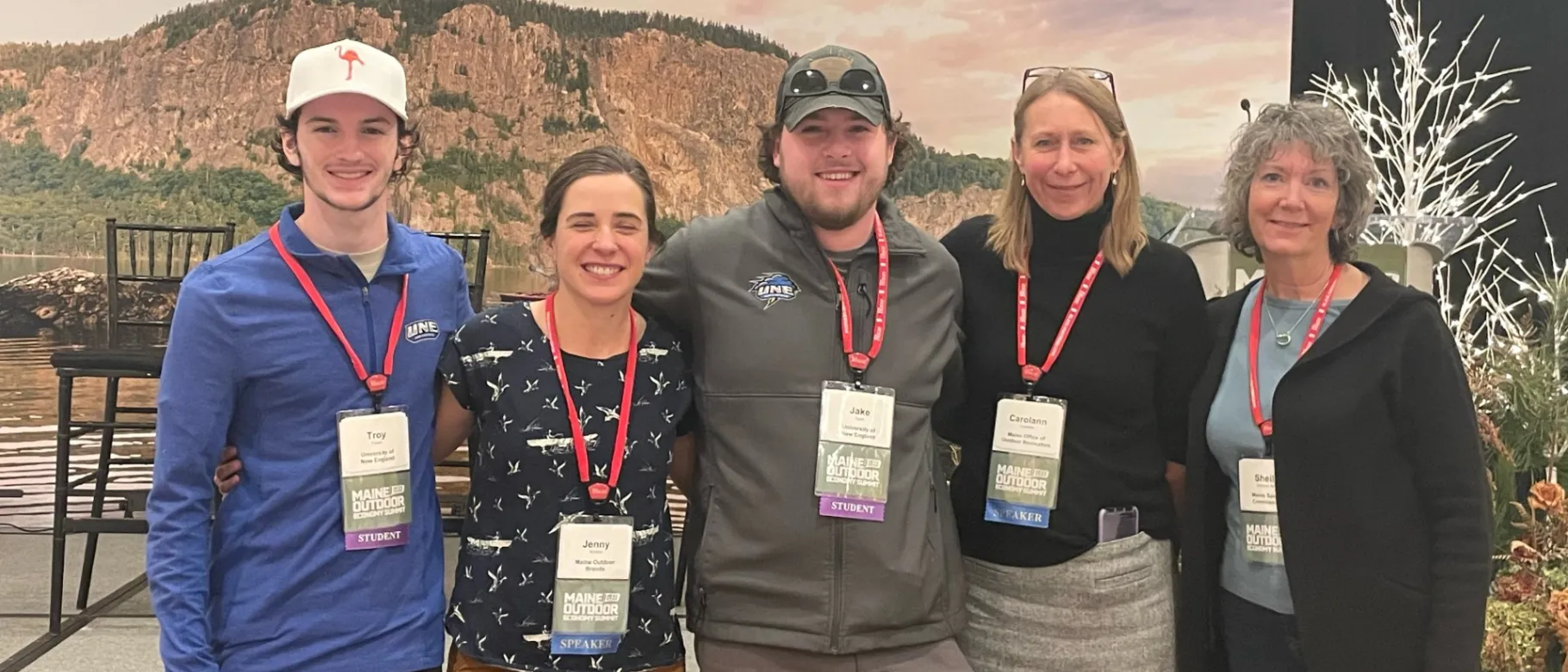 UNE students Troy Fowler and Jake Tobin pose with representatives from Maine's outdoor economy at the Maine Outdoor Economy Summit in Rockland