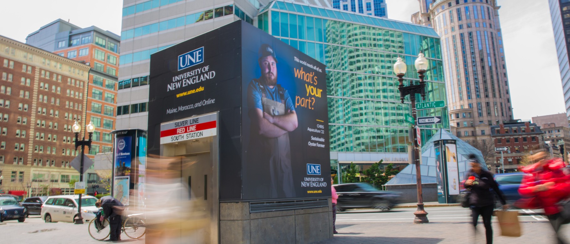 A UNE advertisement adorns a subway entrance in downtown Boston, Mass.