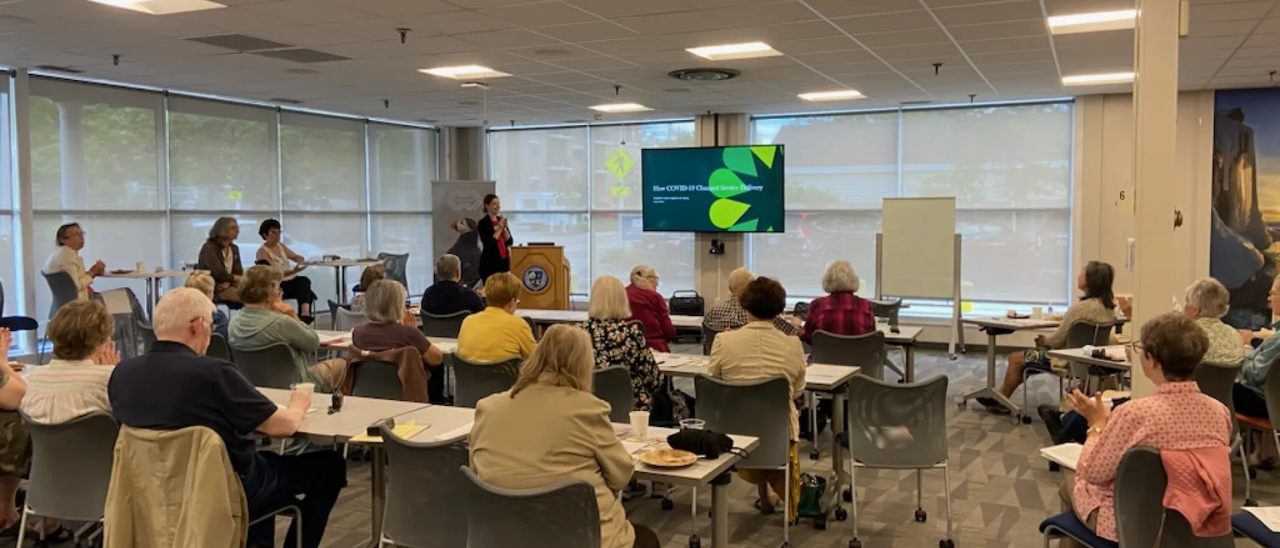 A room of workshop attendees views a presentation