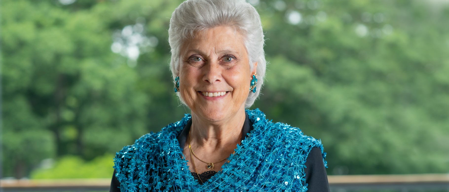 Portrait of Marilyn Gugliucci against trees on the Biddeford Campus