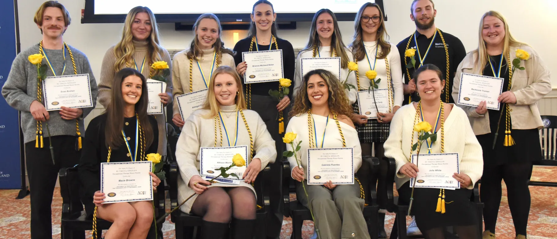 A group of occupational therapy students poses wearing their honor cords