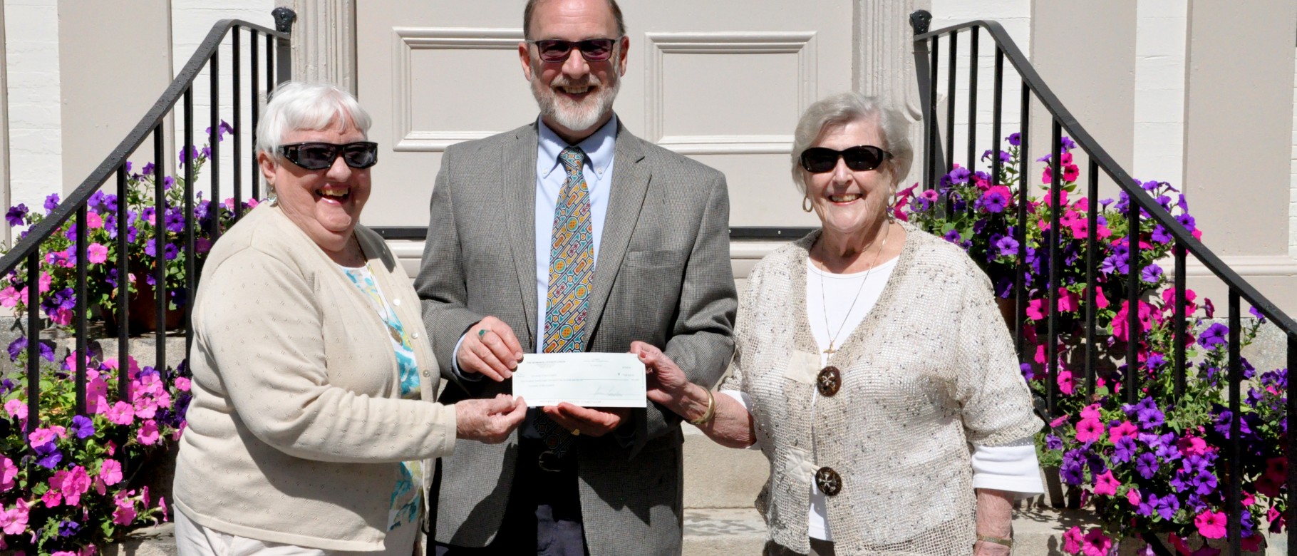 Judith Keegan Sturgeon WC ’49 and Jo Anne Vaughan Thomas Hall WC ’49 present a check to William Chance
