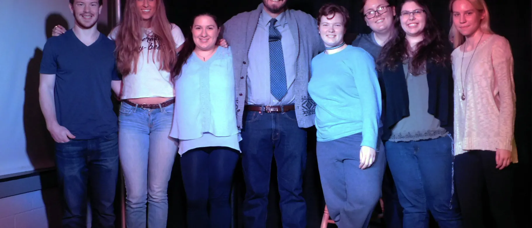 Spoken word poet and activist David Romero with members of UNE's English Club