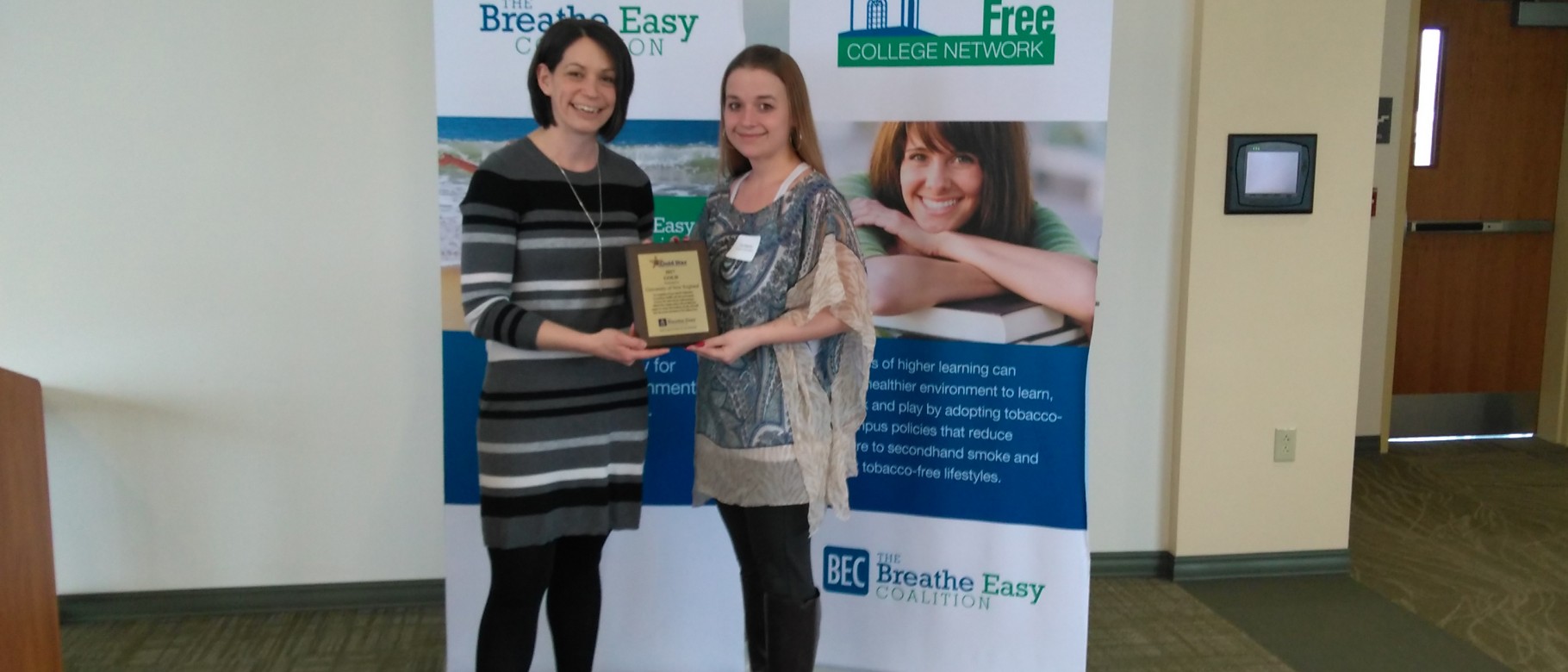 Cat Martins, UNE benefits and disability specialist, accepts the award