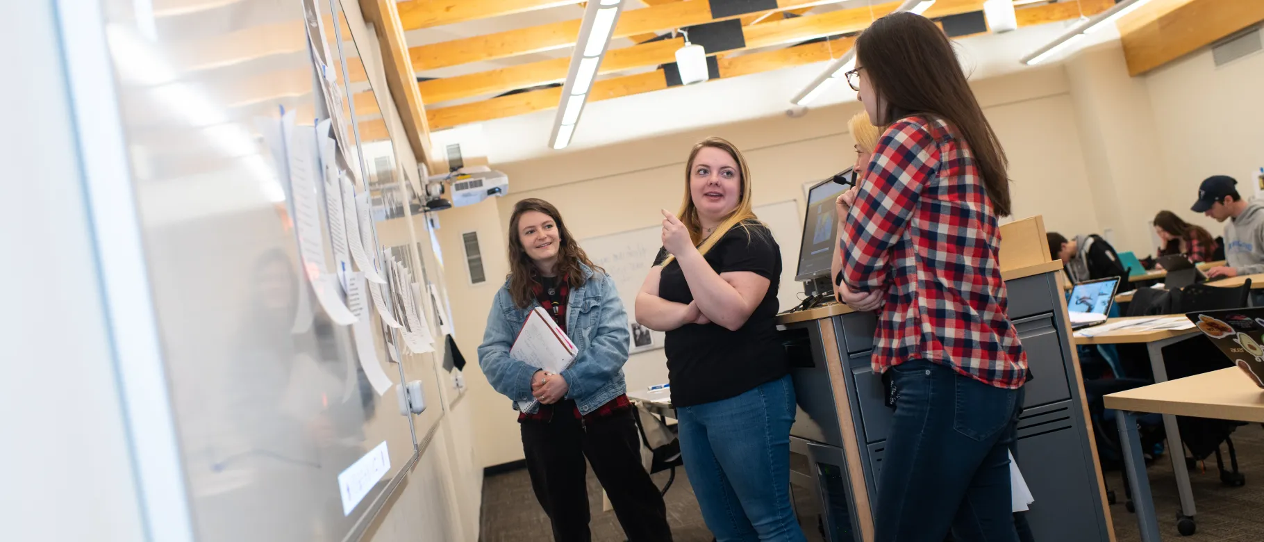 Students discuss ways to display World War II stories on panels for their museum exhibit