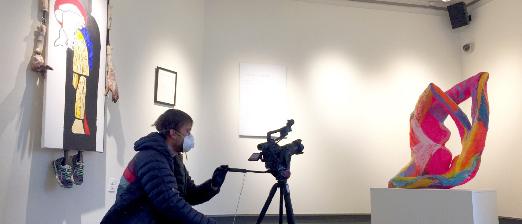 Photo of John Fireman filming "The House of the Soul" exhibition at UNE's Art Gallery