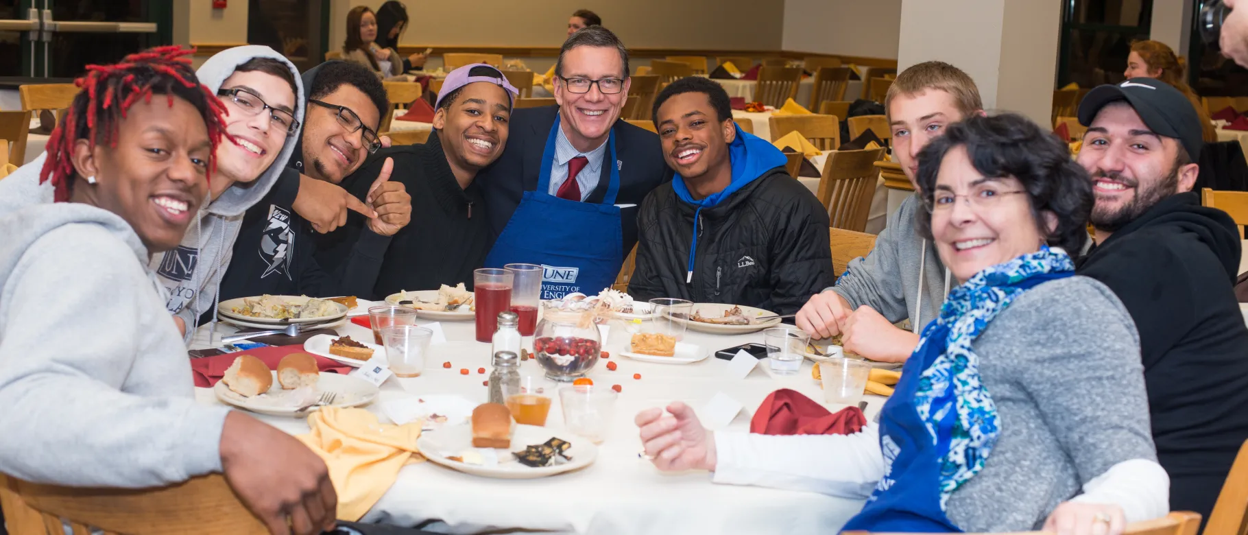 President Herbert and students at annual UNE Thanksgiving meal