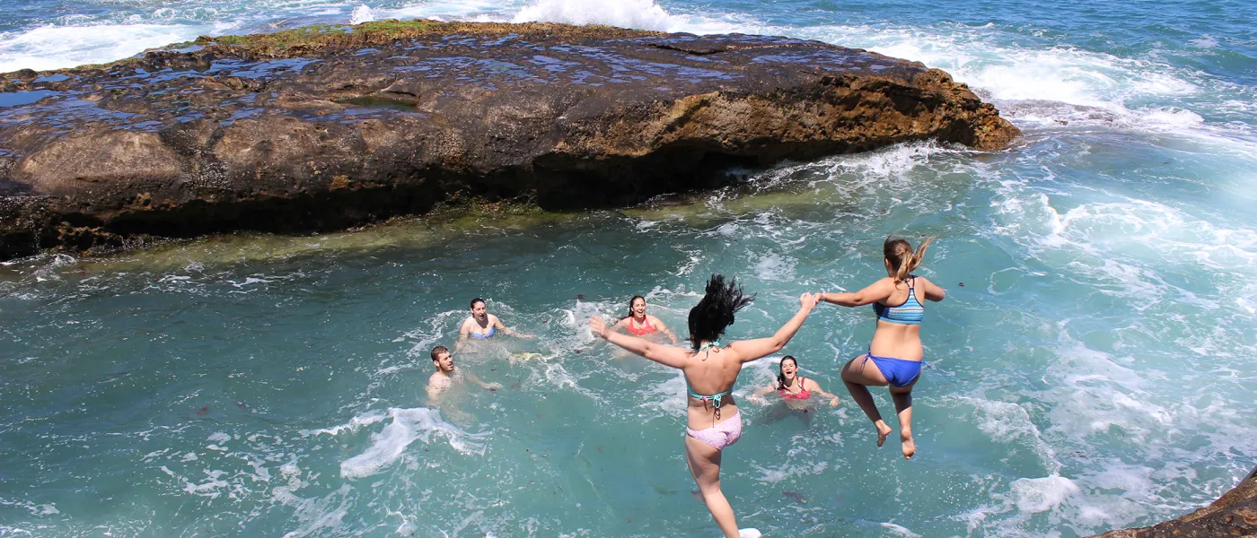 Students jump intro the sea during an excursion to Cherifian