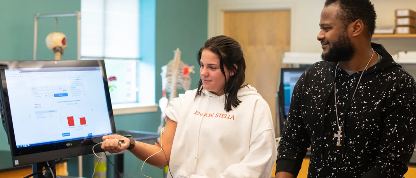 Two U N E health professions students use a computer program