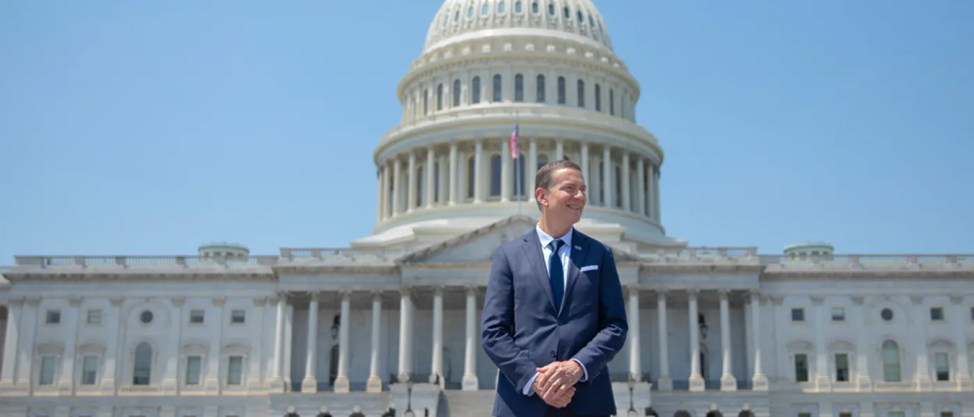 President James Herbert standing in front of the Capitol Building in Washington, D.C.