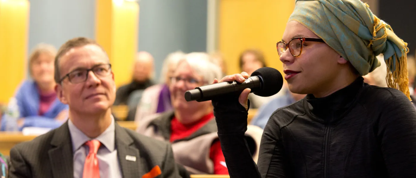 Student asking a question at a UNE event