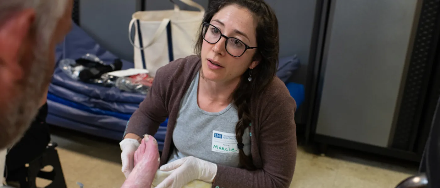 Health student assistants a patient at the foot clinic