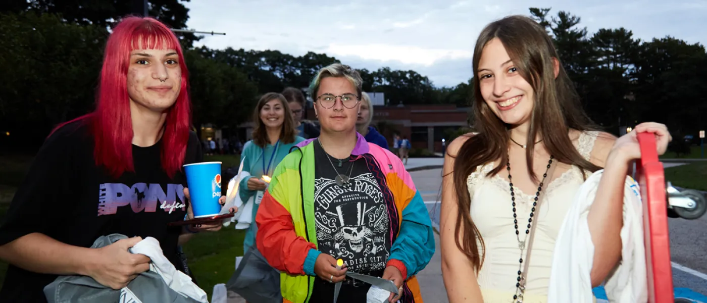 Three students stand together on First Night