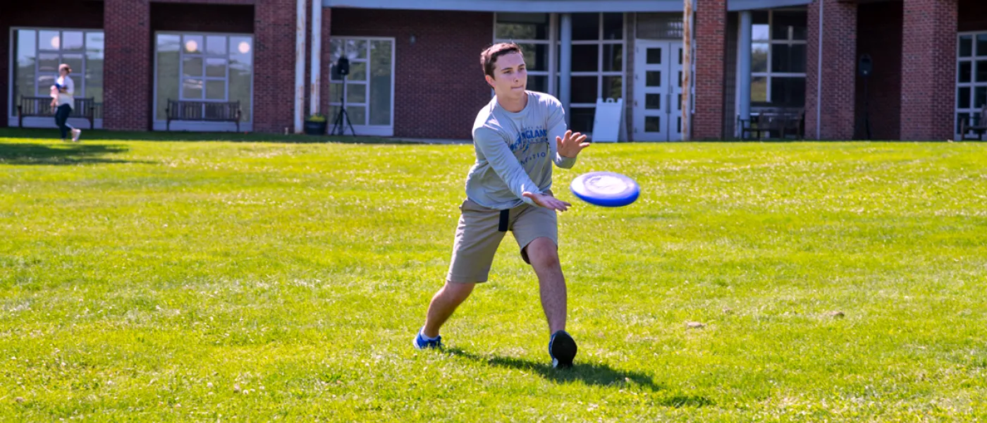 A student catching a frisbee