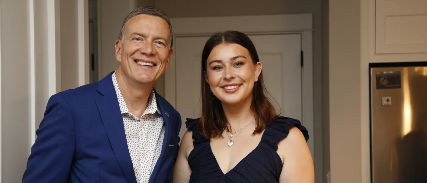 Abbie Anderson poses with UNE President James Herbert