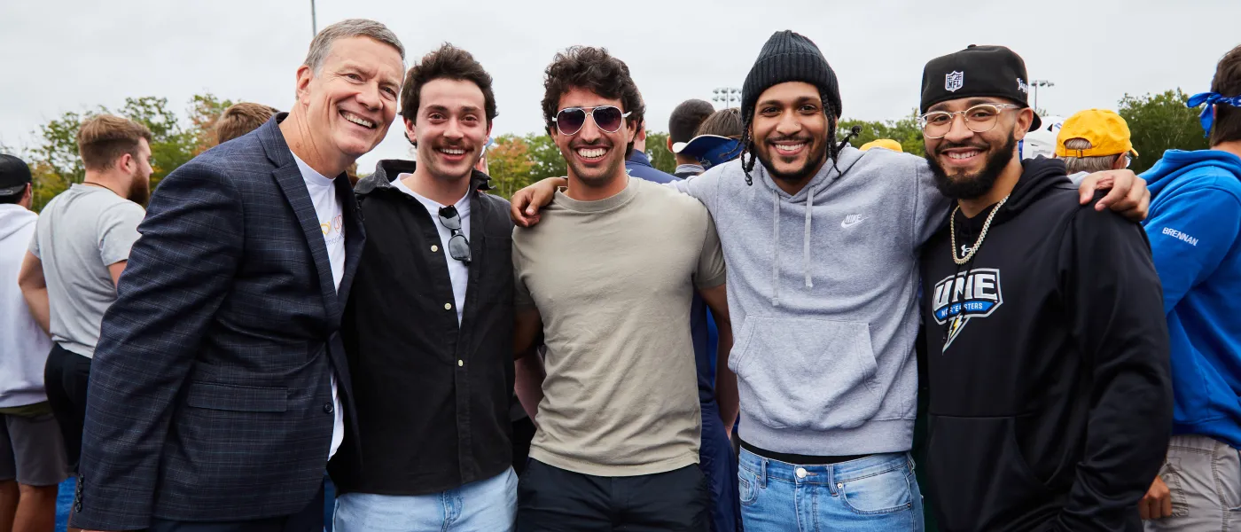 UNE President James Herbert poses with a group of students