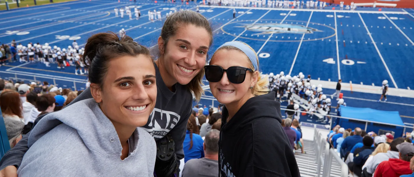 Students pose for a photo in the stands