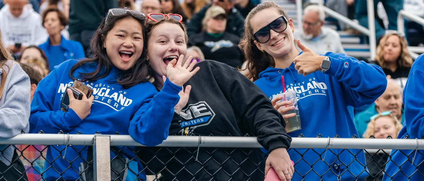 Students pose for photos in the stands