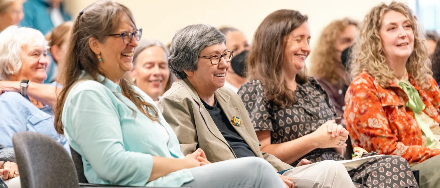 Donna Loring watches from the audience alongside UNE faculty members and friends