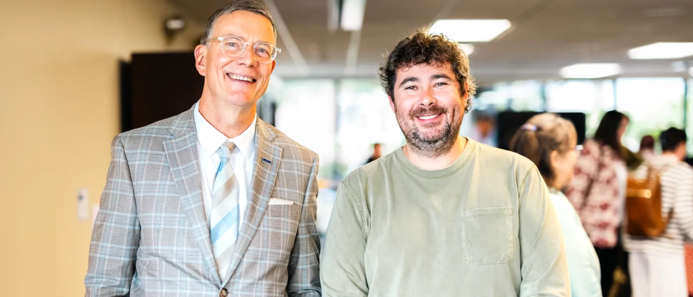 UNE President James Herbert poses with Morgan Talty