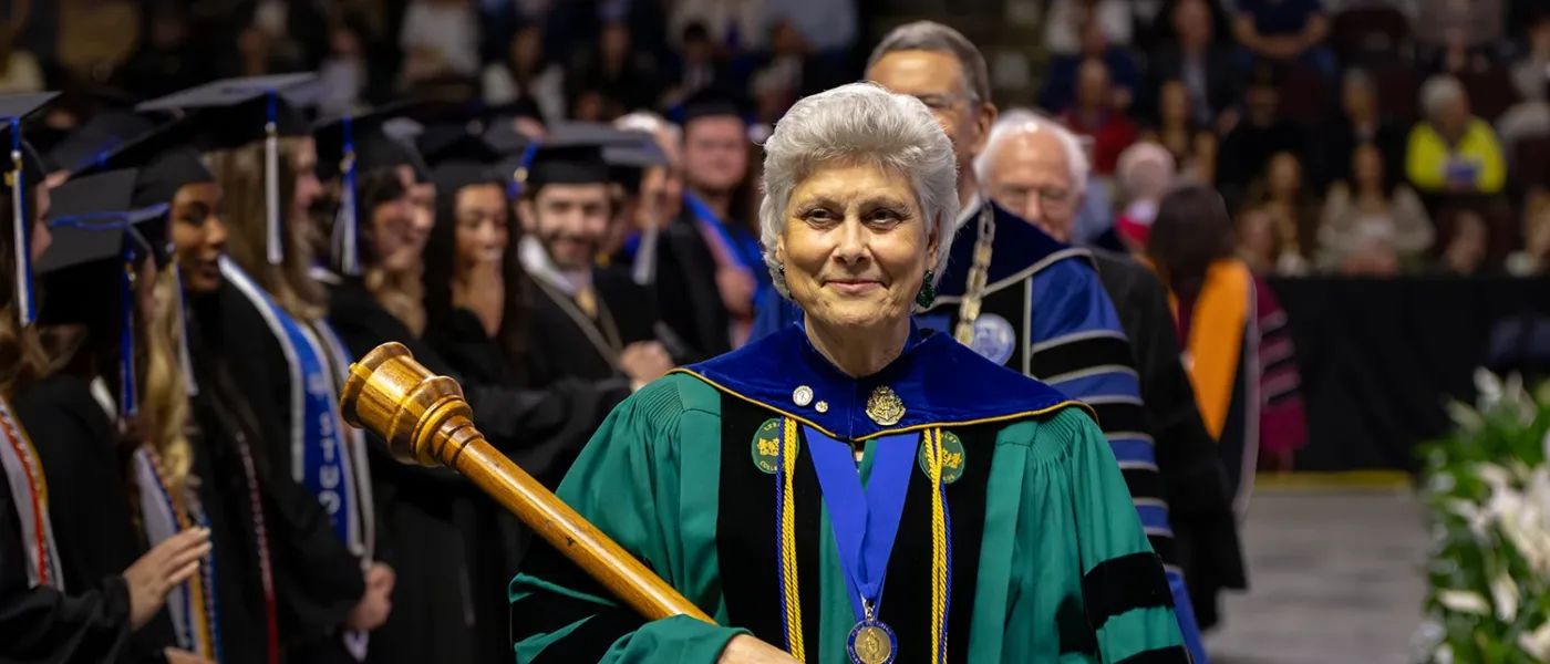 U N E faculty member Marilyn R. Gugliucci,  Ph.D., Geriatrics Education and Research, leads the procession into commencement